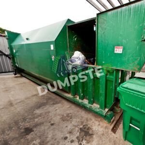 Dumpsters Outside A green dumpster with a matching green lid, sitting in a clean outdoor area.