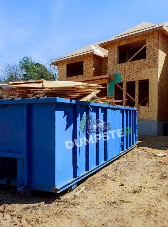 Roofing Dumpsters A blue dumpster is placed outdoors, ready for waste disposal services.